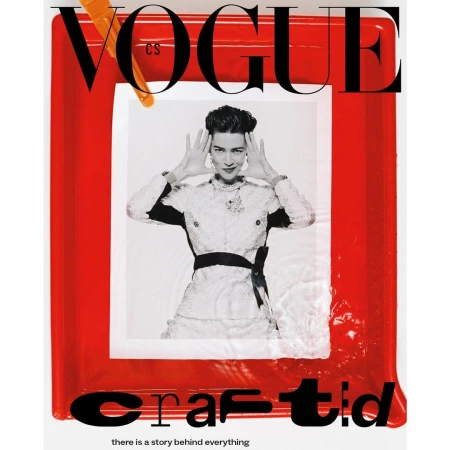 Black and white fashion photo on the cover of Vogue magazine, featuring a woman in an ornate dress, framed by red and orange.