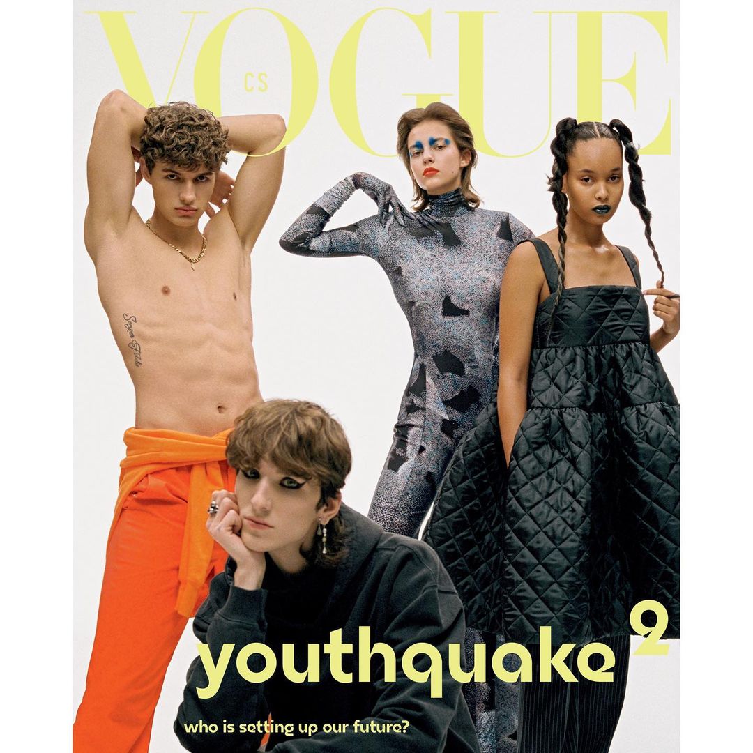 Magazine cover with four young adults in studio setting, featuring bold text and contemporary fashion against a bright backdrop.