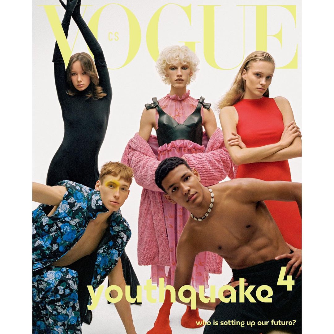 Vogue cover featuring five models in various outfits against a white backdrop, showcasing diverse fashion styles and vibrant colors.