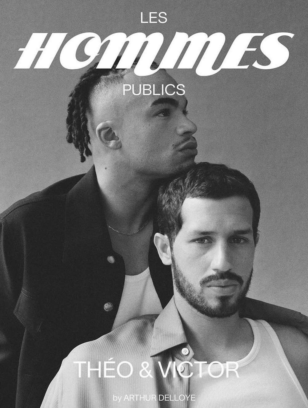 Black and white magazine cover featuring two adult men posing closely, with the title 'Les Hommes Publics' displayed prominently.