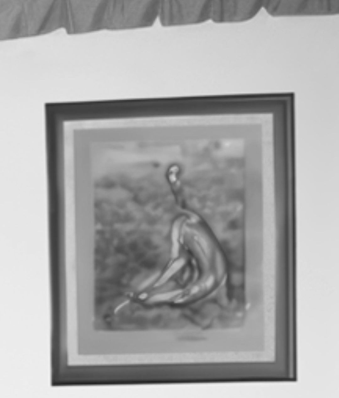 Monochrome framed art print featuring a human form in a garden-like setting, hanging on a wall, with top-of-frame white drapery.