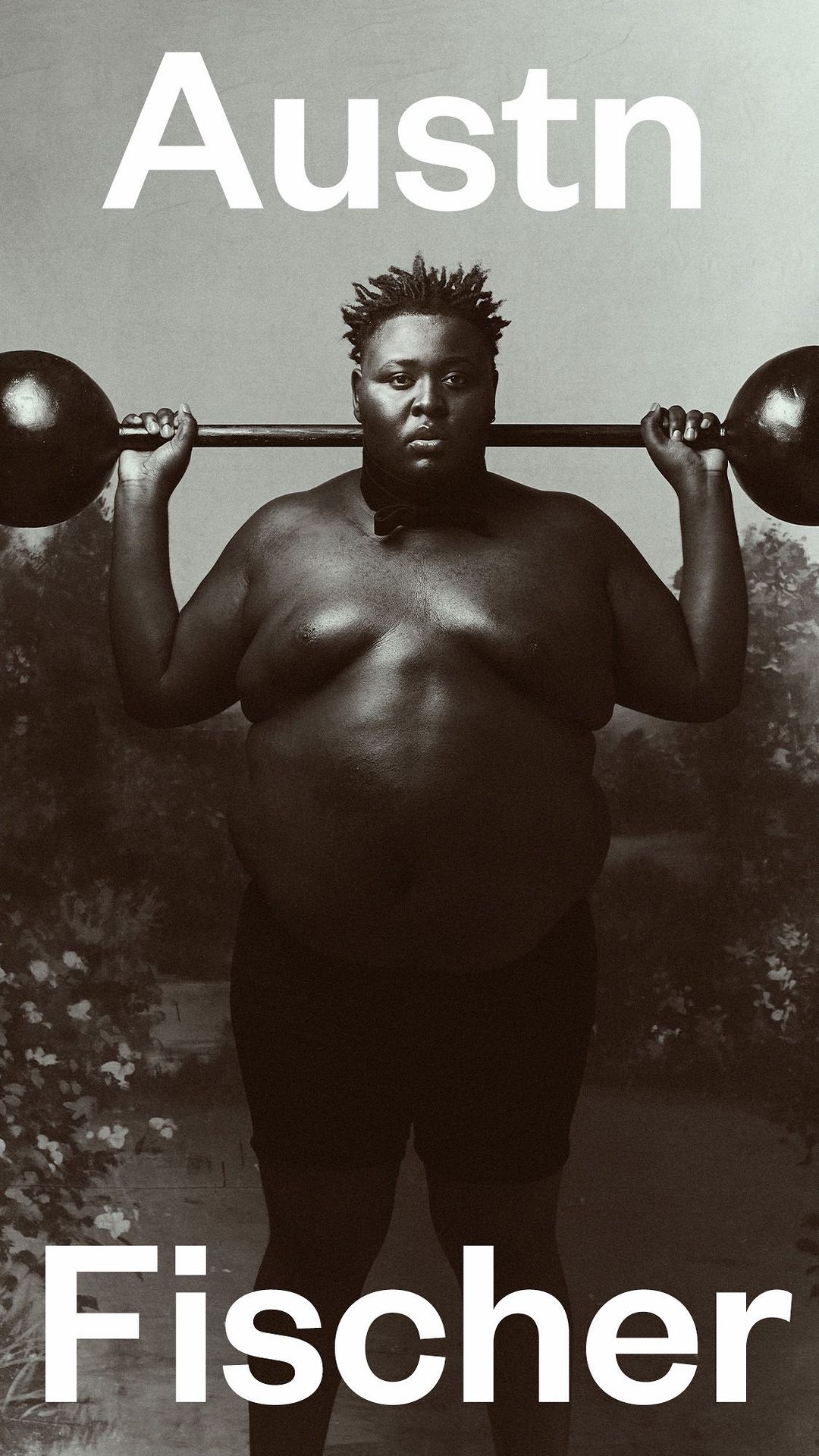 Monochrome portrait of a person lifting a barbell, with 'Austn' and 'Fischer' in white text above and below, against a studio backdrop.
