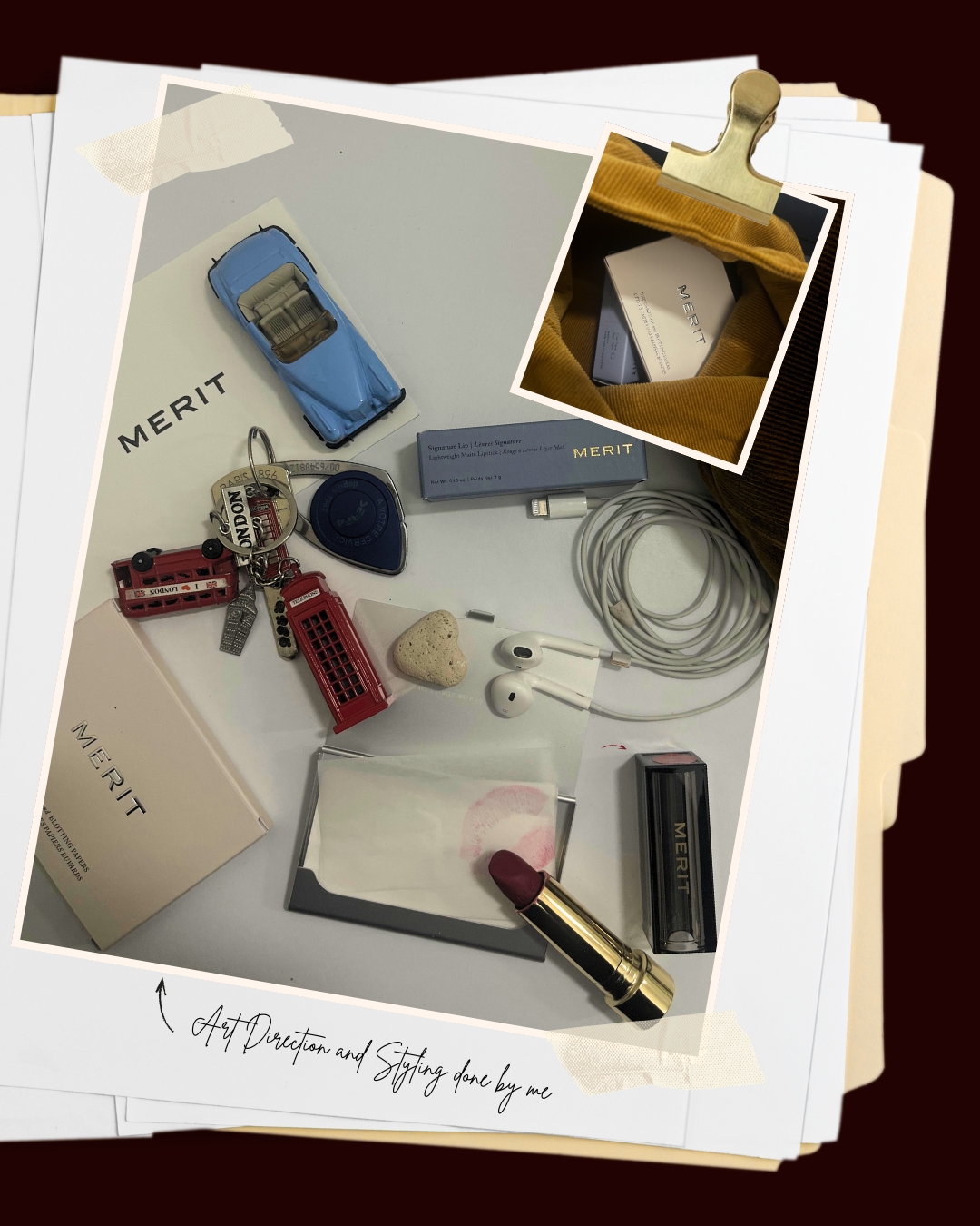 Overhead shot of a curated collection of lifestyle objects, including a toy car, lipstick, and accessories arranged on a white surface.