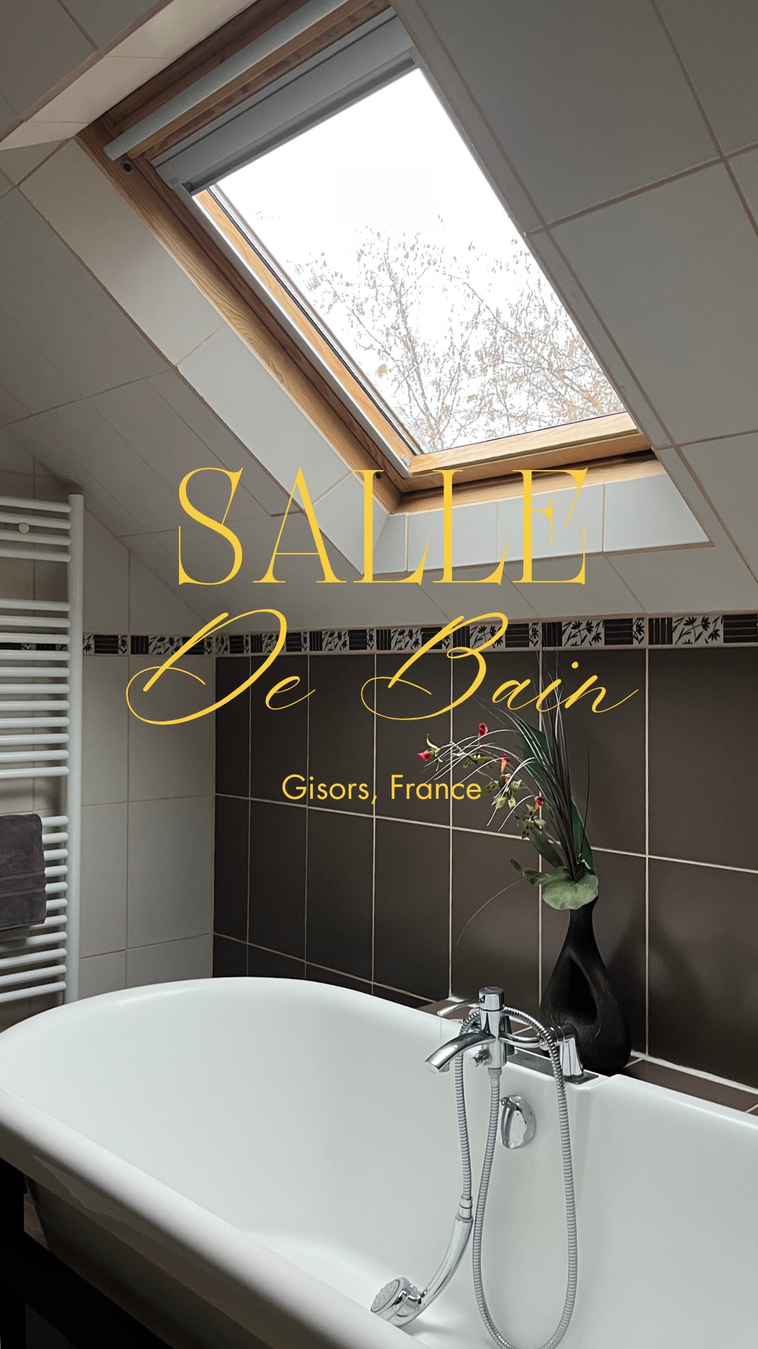 Bathroom interior featuring a white bathtub, brown tiled walls, and a skylight, creating a bright and modern aesthetic.