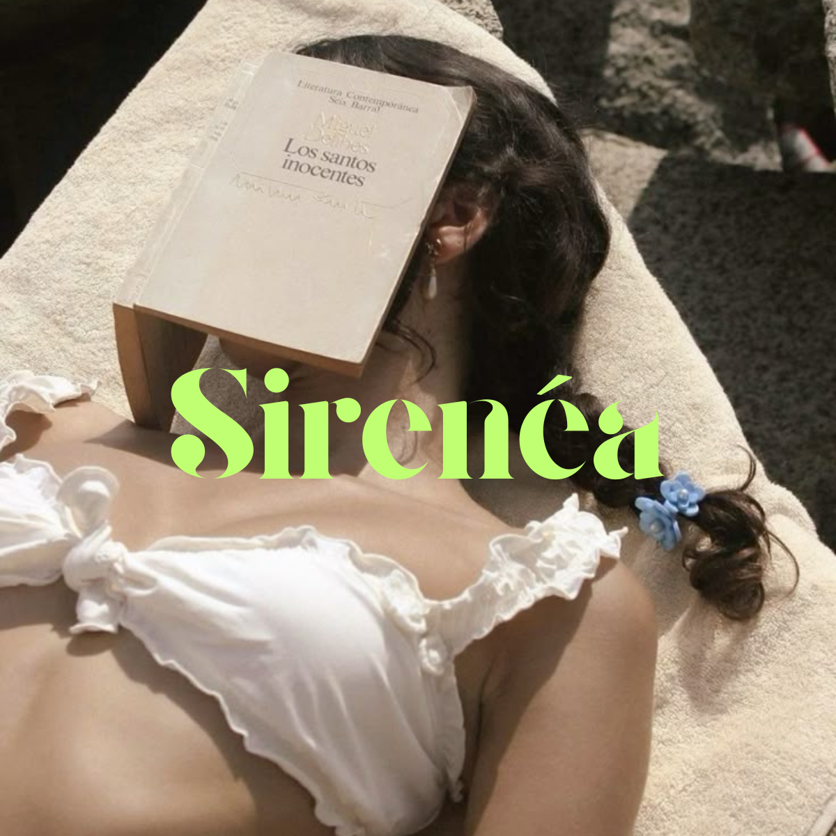 Woman lying on towel with book covering face, wearing white swimsuit, with visible green text overlay. Outdoor setting, sunny day.