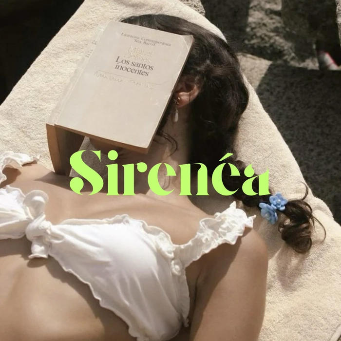 Woman wearing a white ruffled top lying outdoors with an open book covering her face, featuring bright green typography overlaid.