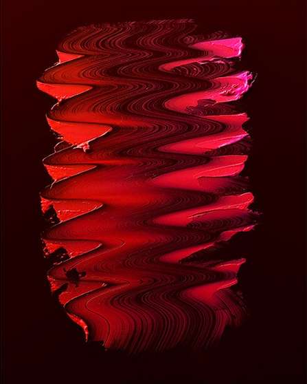 Abstract smudged texture art with red and pink hues on a dark background, creating a visual effect suggestive of movement and depth.