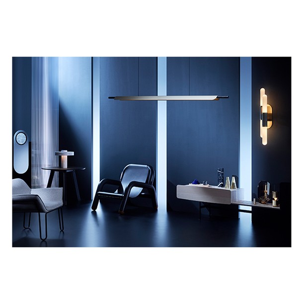 Contemporary interior showcases minimalist furniture, a sleek pendant light, a modern sconce, and muted color palette in a home setting.