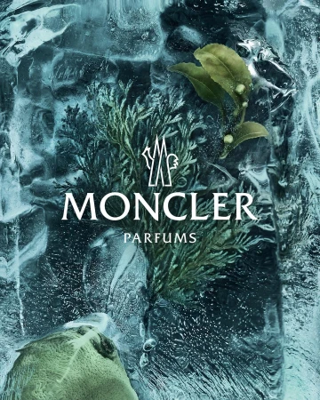 Moncler Parfums advertisement features ice with frozen plant sprigs in shades of green and white text logo on a dark blue background.