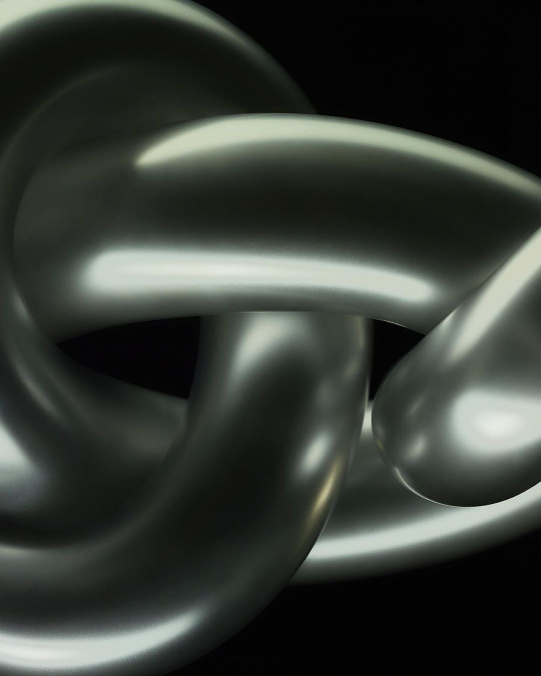Close-up of a metallic chain with interconnected links against a black background, showcasing its form, texture, and light reflection.