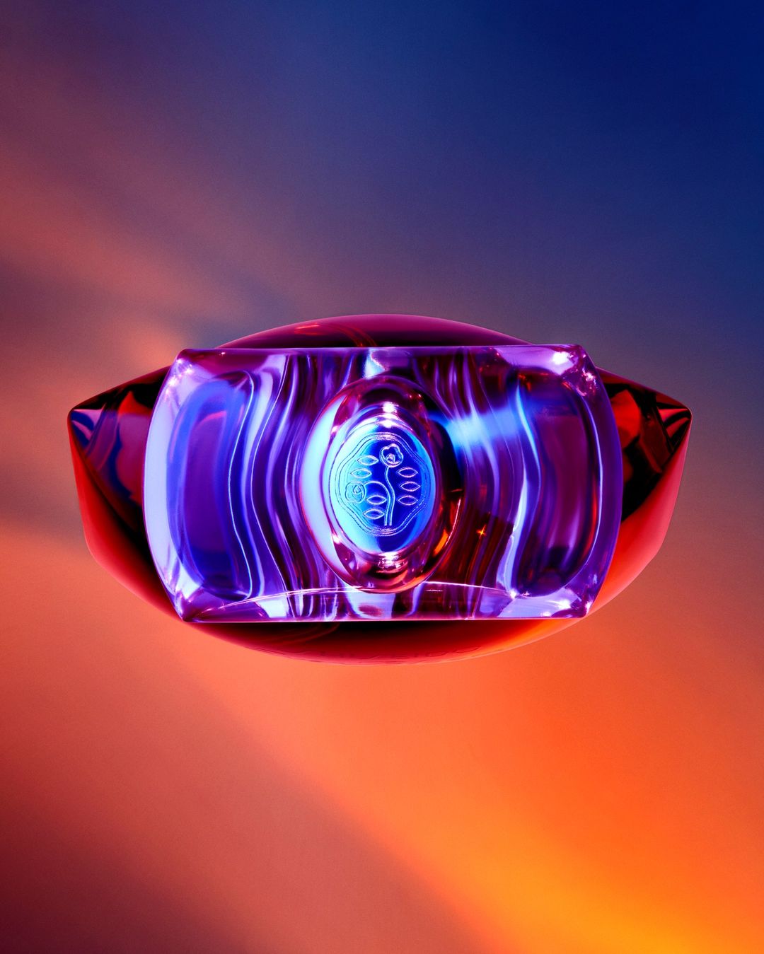 Close-up product shot of a glass perfume bottle with orange and blue gradient background, highlighting its abstract shape and design.