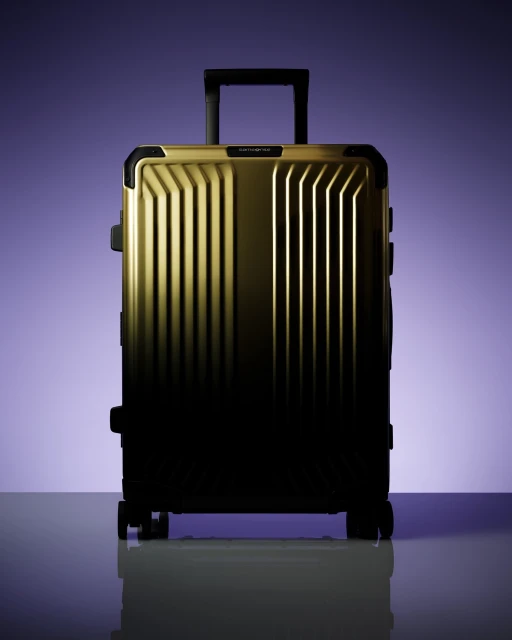 Studio shot of a wheeled suitcase on a reflective surface against a graded blue backdrop. Travel concept imagery.