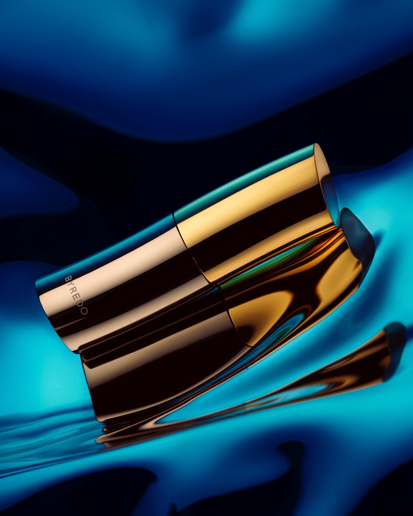 Glamorous gold and black cosmetic tube presented against a vibrant blue backdrop, reflecting its elegant design and sleek packaging.