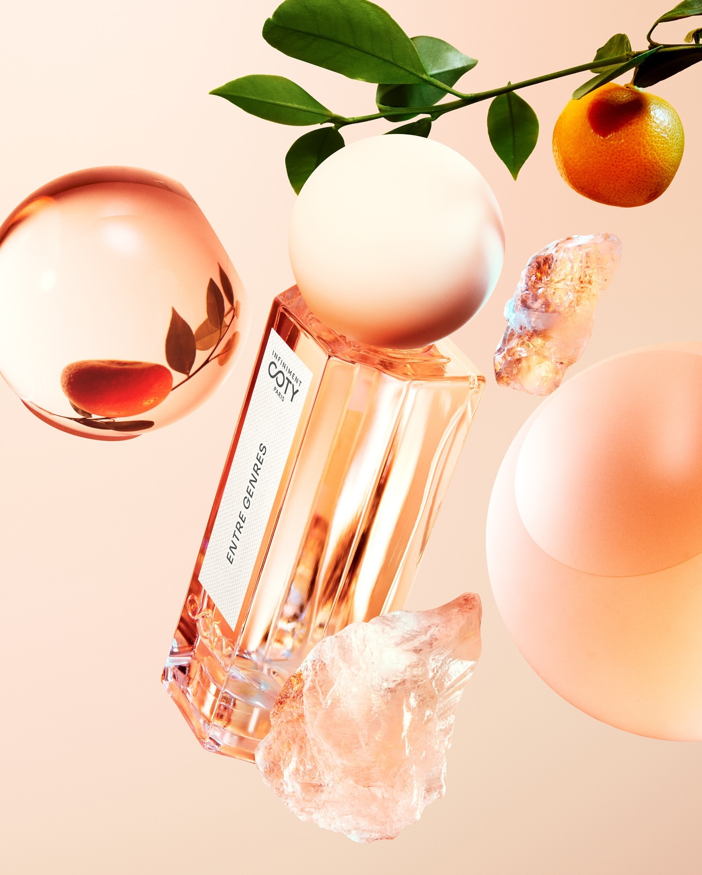 Perfume bottle with geometric shapes, orange, and leaves on a soft pink background for a beauty or fragrance advertisement.