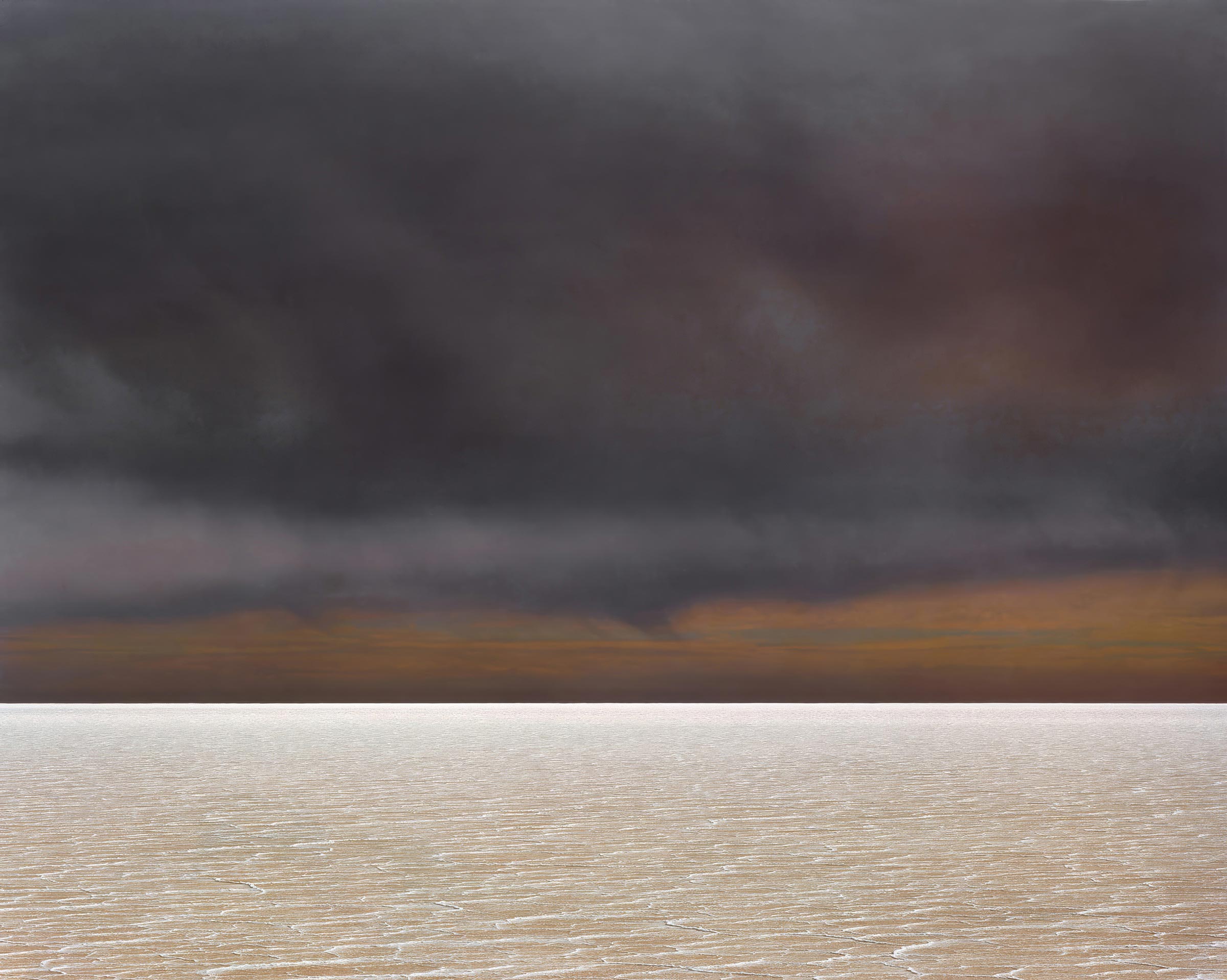 Dramatic landscape featuring a bright, expansive salt flat under a dark, ominous sky with low-hanging clouds and warm horizon colors.