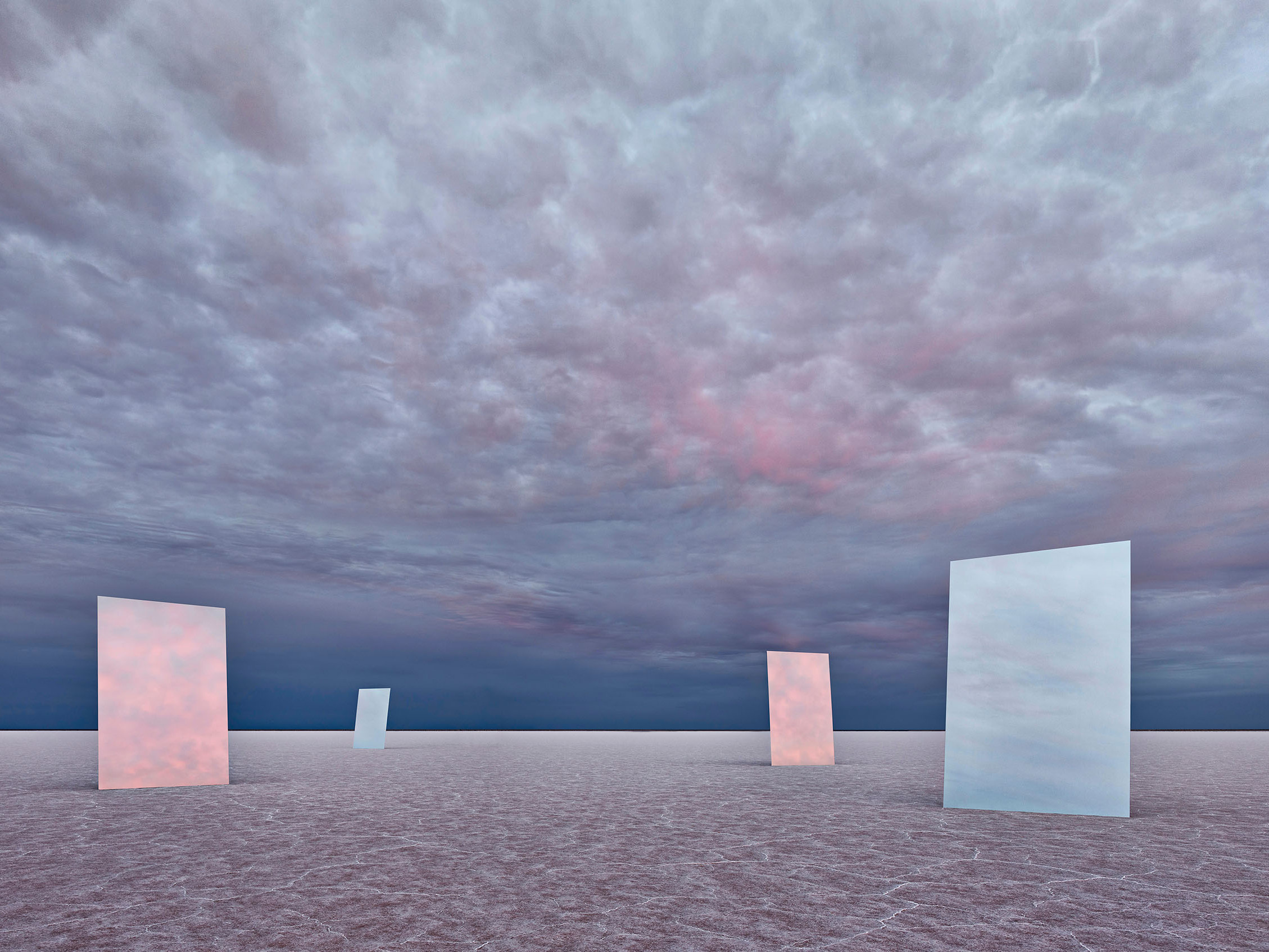 Minimalist landscape with four rectangular reflective panels on a flat plane under a dramatic cloudy sky, creating a surreal atmosphere.
