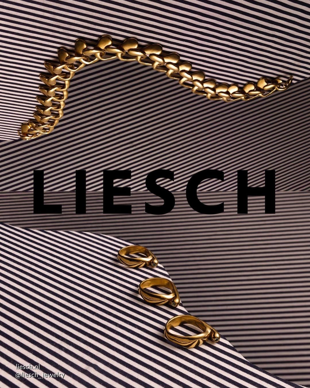 Promotional still life product shot featuring gold jewelry, including a bracelet and rings, displayed on a striped surface.
