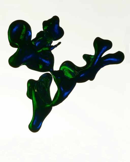 Abstract blue and green glossy ink blotches on a white background create an organic, flowing shape with vibrant color contrasts.