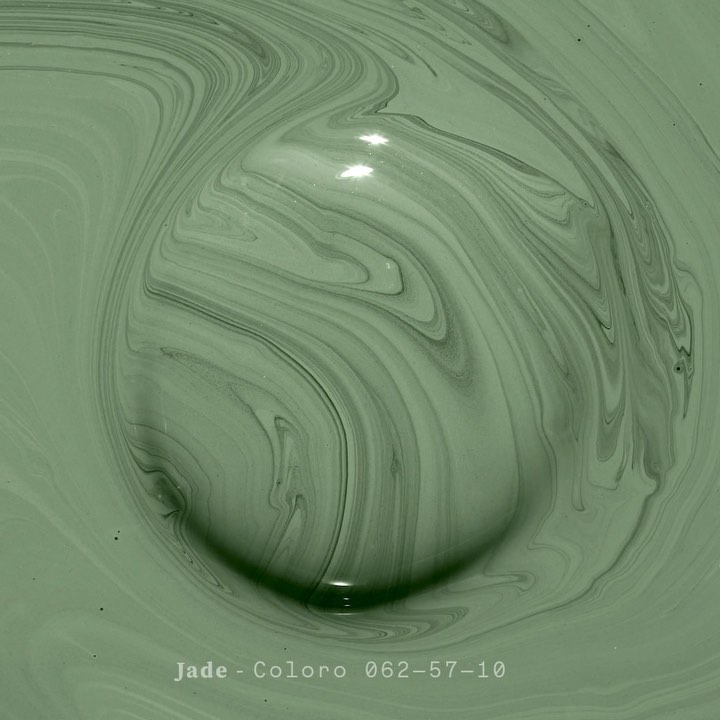 Macro abstract of swirling, light green paint with dark green marbling and shadows creates a soothing, organic, and textured visual.