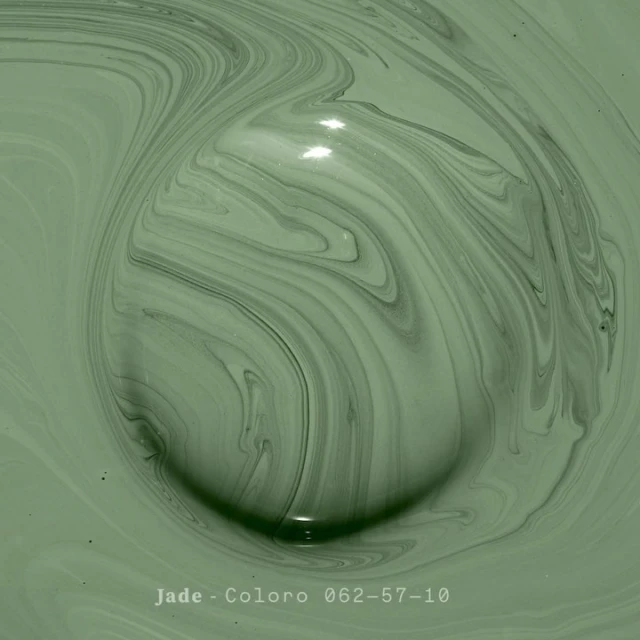 Macro abstract of swirling, light green paint with dark green marbling and shadows creates a soothing, organic, and textured visual.