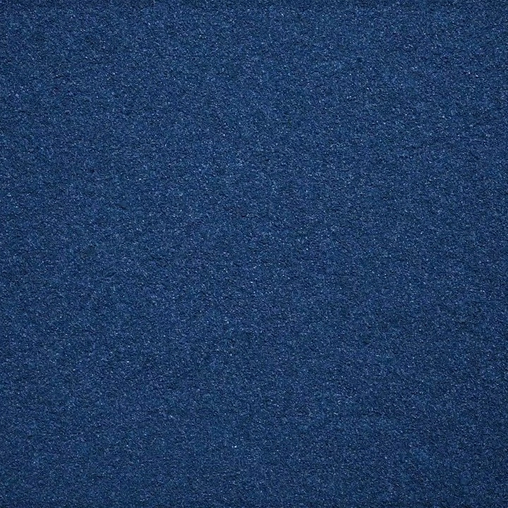 Close-up of a dark blue textured fabric surface with a dense woven or felted grain pattern filling the frame.