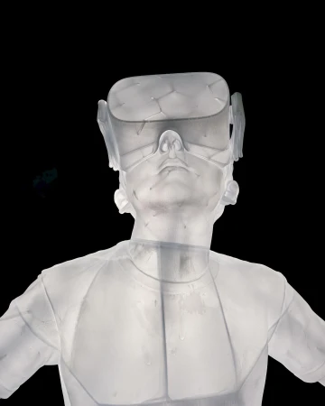 Translucent human bust wears a VR headset against black. The white sculpture is set against a stark, dark backdrop.