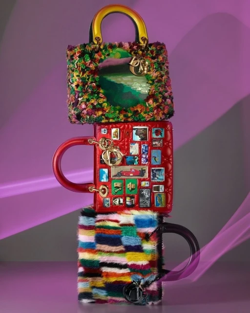 Stacked Dior Lady handbags, each uniquely decorated with landscape art, stamps, and colorful patchwork, creating a tower of fashion.