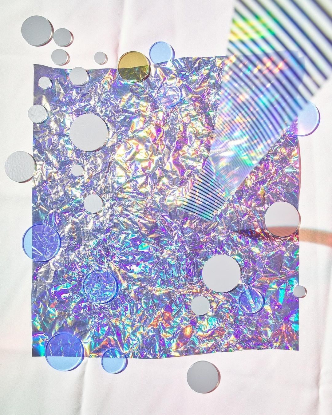 Abstract studio shot of iridescent square with circle discs, creating a holographic, textural, and geometric background, ideal for design.