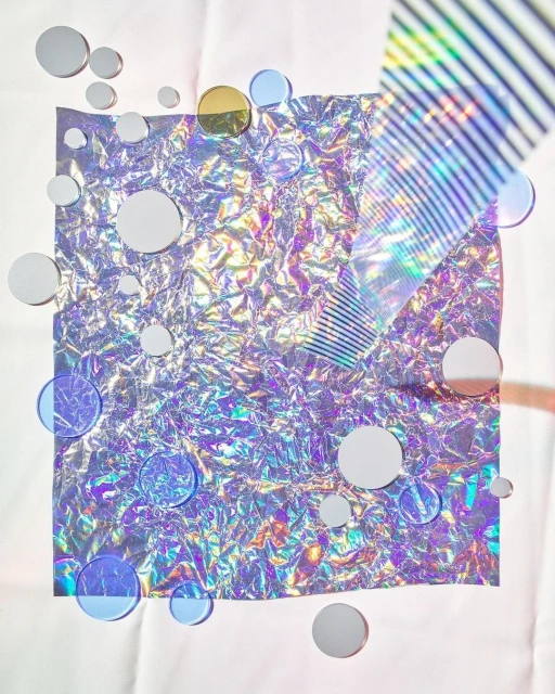 Abstract studio shot of iridescent square with circle discs, creating a holographic, textural, and geometric background, ideal for design.