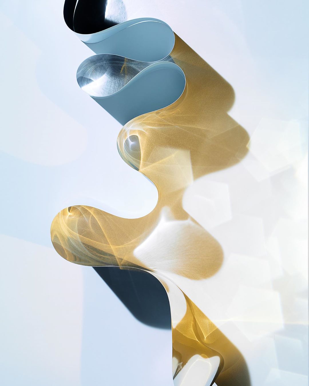Abstract art of wavy, translucent material in blue, silver, and gold with light and shadow patterns on a white background.