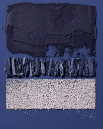 Close-up macro shot of three distinct cosmetic powder swatches in shades of purple and white on a solid blue background.