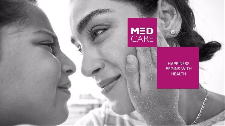 Close-up black and white image features two adult females with faces near each other, with healthcare text overlay and beach background.