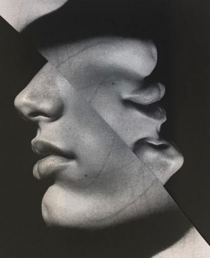 Monochrome image featuring a fragmented human face in profile with dark shadows and subtle textures against a dark background.
