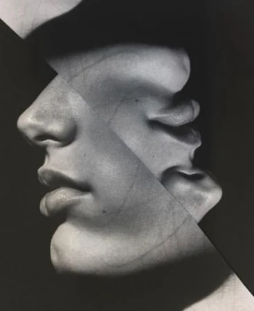 Monochrome image featuring a fragmented human face in profile with dark shadows and subtle textures against a dark background.