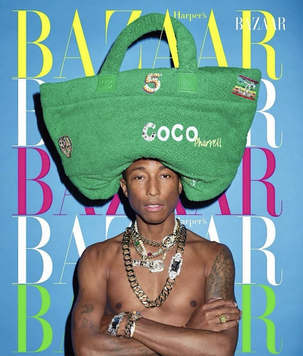Pharrell Williams, shirtless, wearing jewelry and a handbag on his head, poses for a Bazaar cover against a blue background.