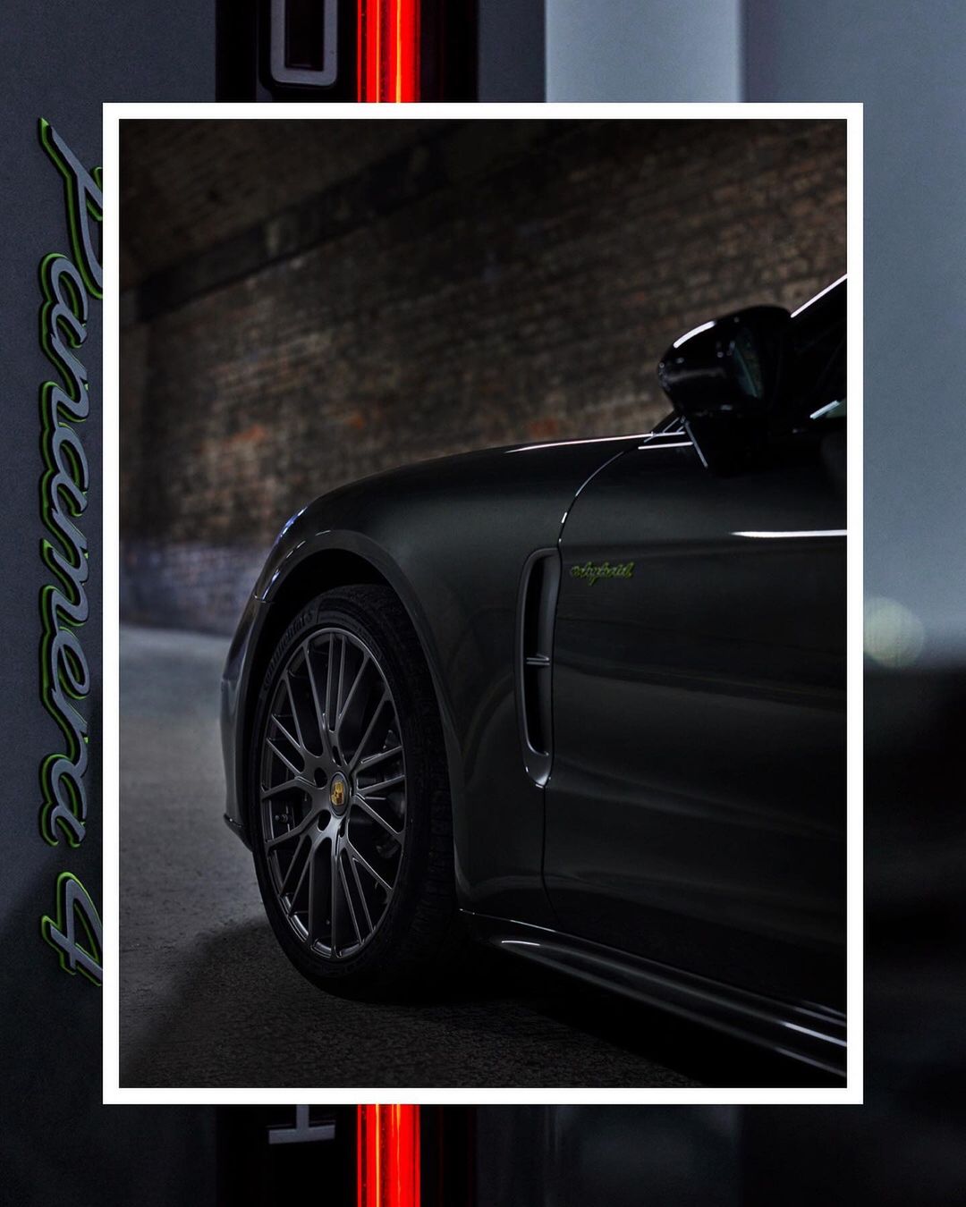 Side view of a dark gray Porsche Panamera 4 e-hybrid with brick wall and red neon lighting in the background, car's tire visible.