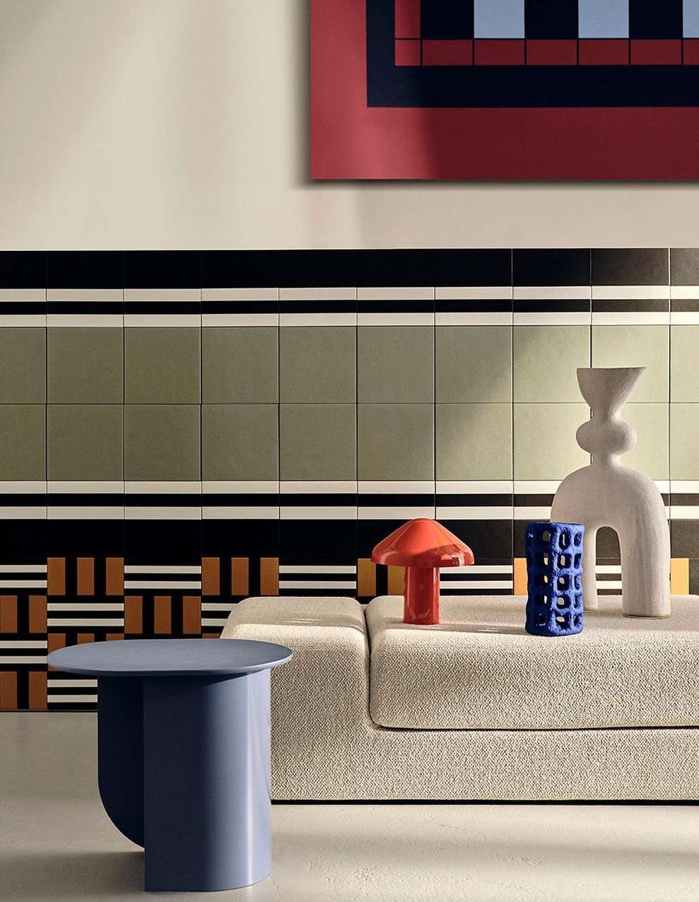 Interior shot featuring blue side table, sofa with decor objects, and graphic art on the wall, creating a modern and stylish living space.