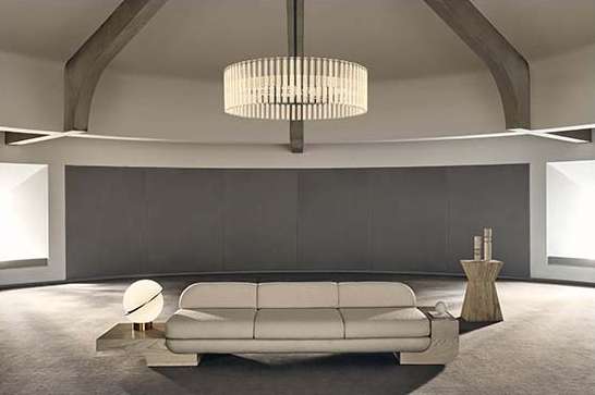 Contemporary living room interior showcasing a cream-colored sofa, circular light fixture, and architectural beams in a minimalist space.