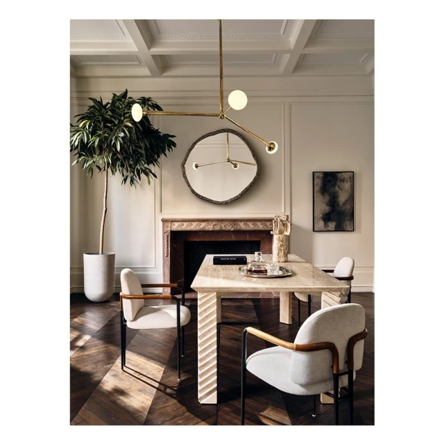 Dining room interior featuring a marble table, modern chandelier, upholstered chairs, and a potted plant, creating a stylish and inviting space.