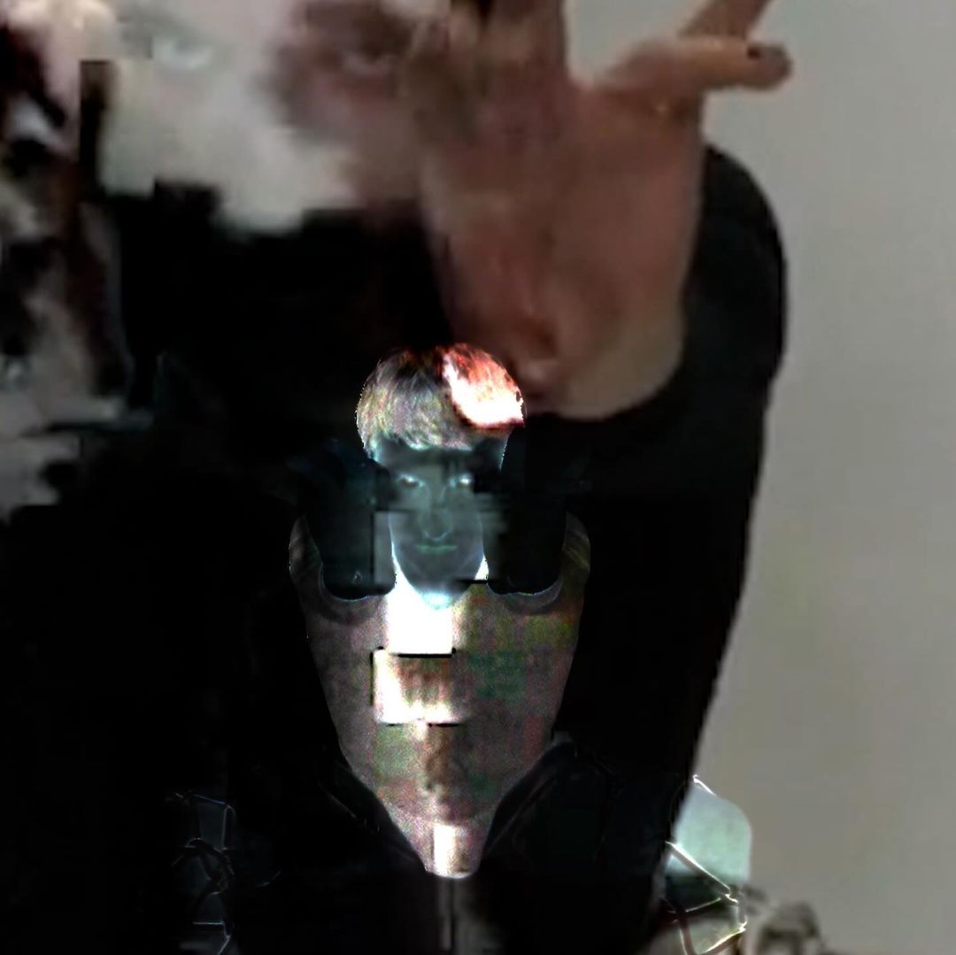 Digital art features a person with fair skin and short hair, distorted through a glitch effect, set against a light background.