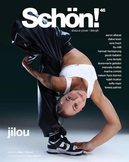 Magazine cover featuring an adult female in athletic wear posing upside down, wearing Nike sneakers and black tracksuit bottoms, set against a dark backdrop.