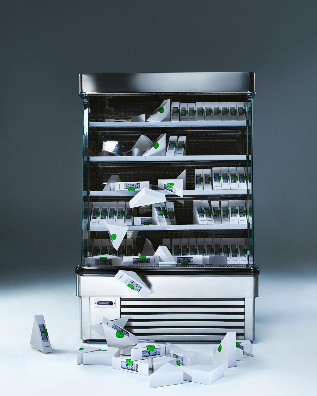 A refrigerator filled with neatly stacked and scattered triangular sandwich packets in a well-lit, clean environment, creating an organized, yet dynamic scene.