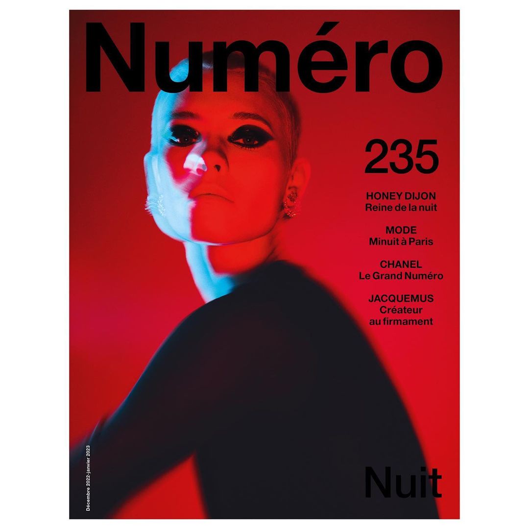 Magazine cover featuring a model with dark eye makeup, red and blue lighting, and the 'Numéro' masthead.