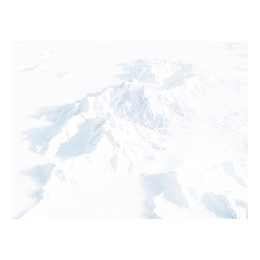 Aerial view of a snow-covered mountain range with soft lighting and a minimalist aesthetic, ideal for travel or nature themes.