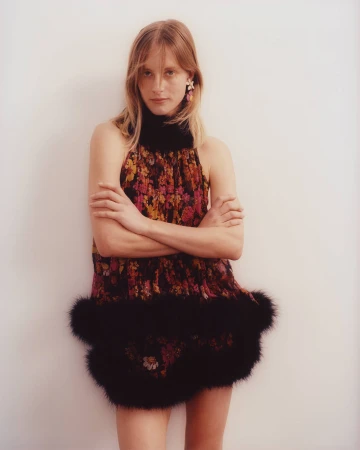 Woman with arms crossed wearing a floral dress with black faux fur trim by photographer Ben Parks.