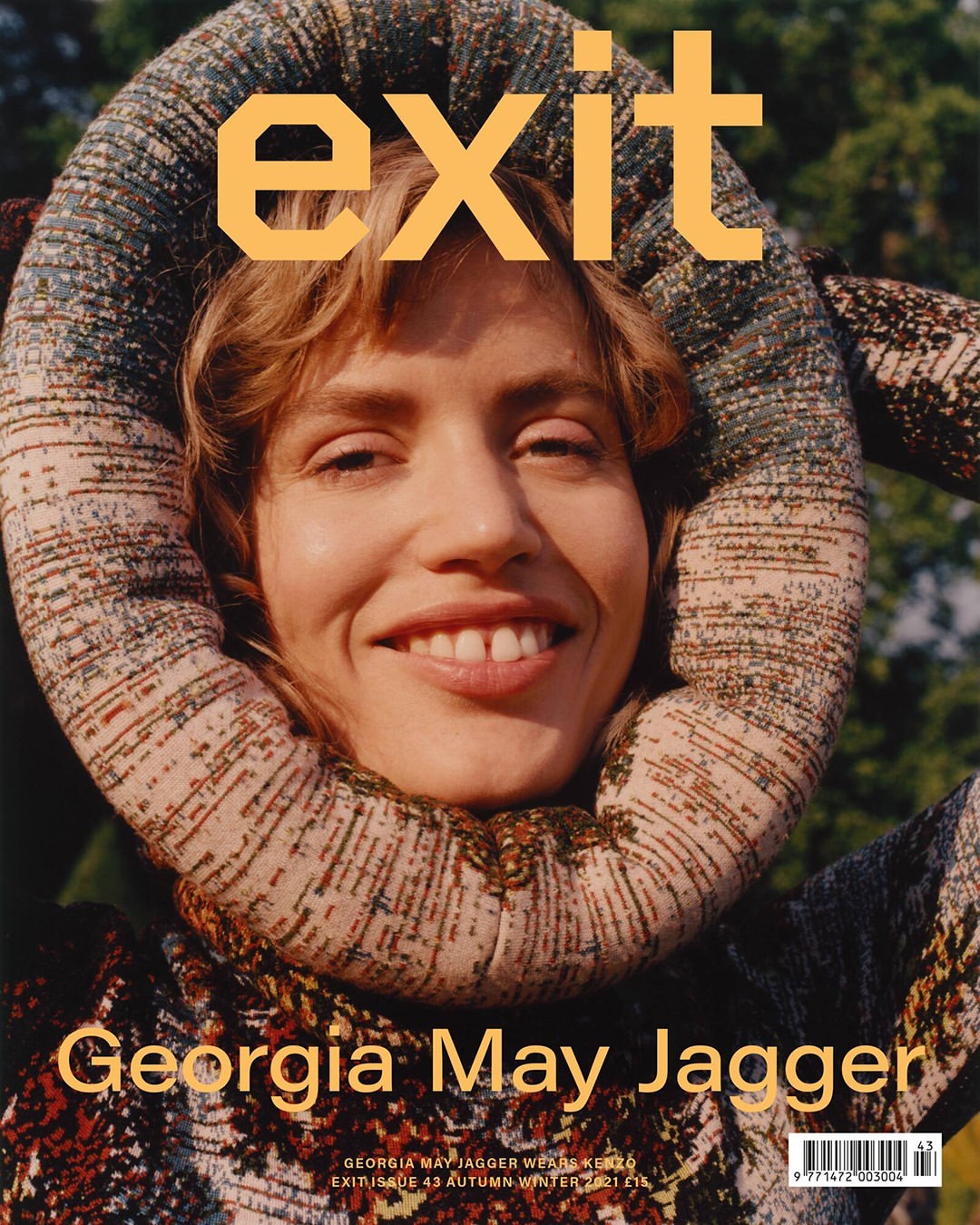 Magazine cover featuring Georgia May Jagger with a patterned head wrap, smiling at the camera in an outdoor setting.