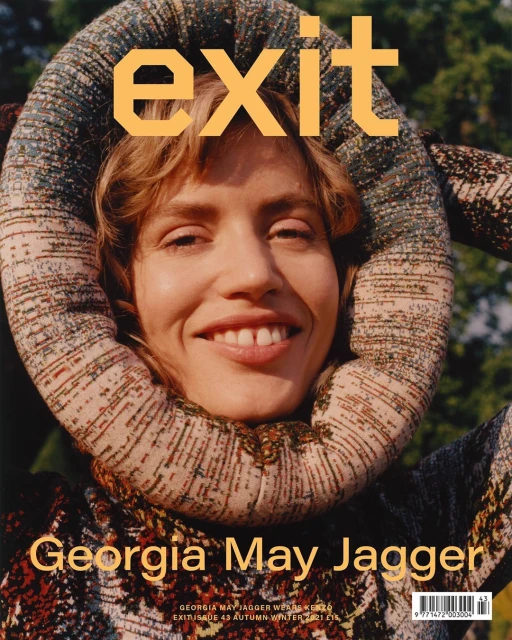 Magazine cover featuring Georgia May Jagger with a patterned head wrap, smiling at the camera in an outdoor setting.