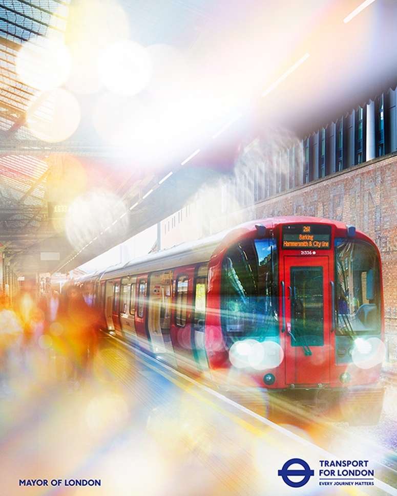 Red London Underground train shown speeding into a station platform, with blurred figures and diffused bokeh effects adding motion and light.