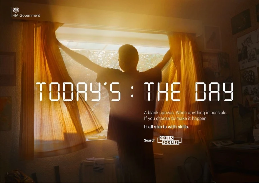Person opening curtains in a bedroom, revealing bright sunlight. An advertisement promotes skills for life and new opportunities.