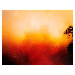Vibrant abstract water surface reflecting warm orange and red light with concentric ripples from raindrops and dark silhouette shadows on the right